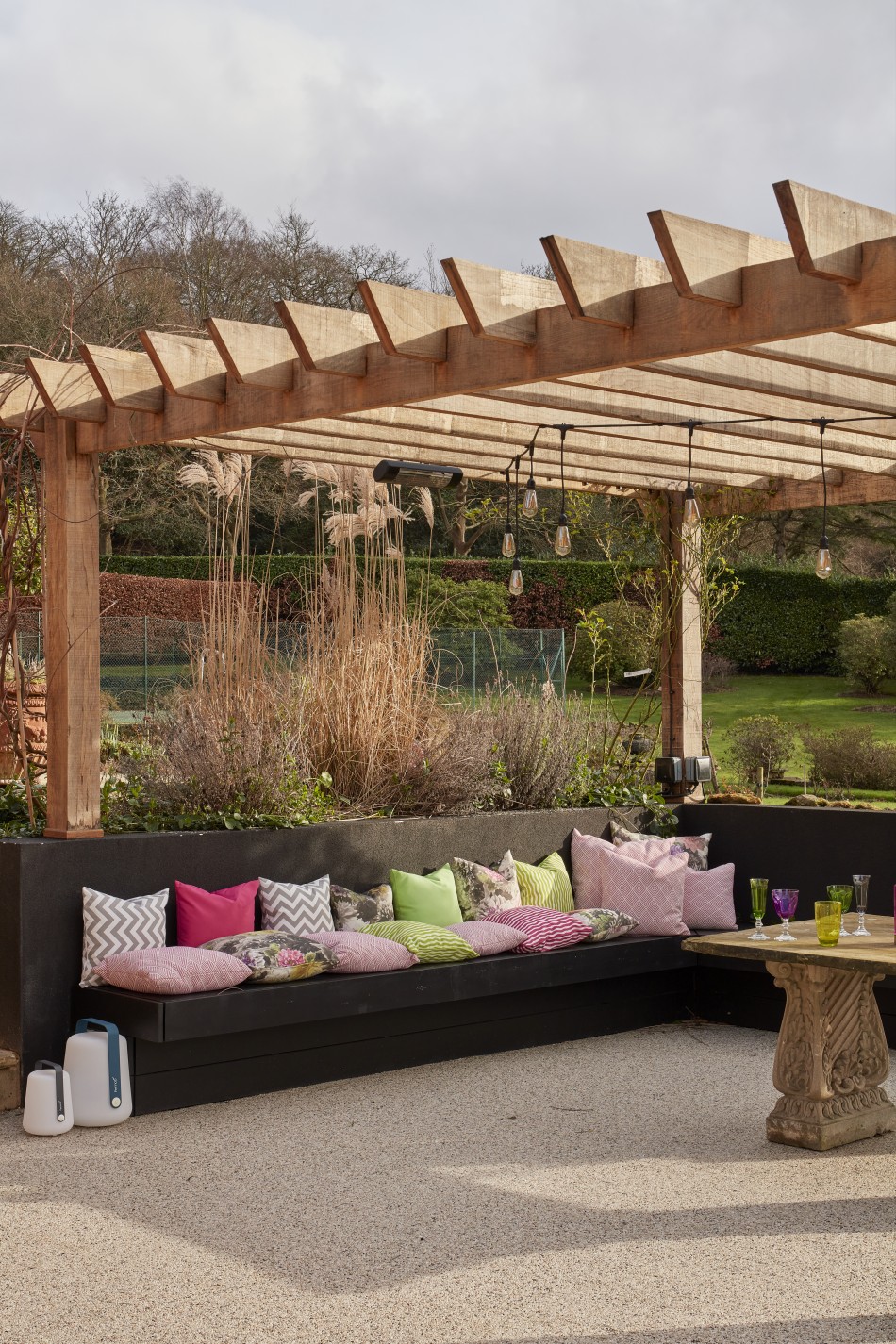 Pool house garden design with custom outdoor seating and pergola for luxury outdoor living.