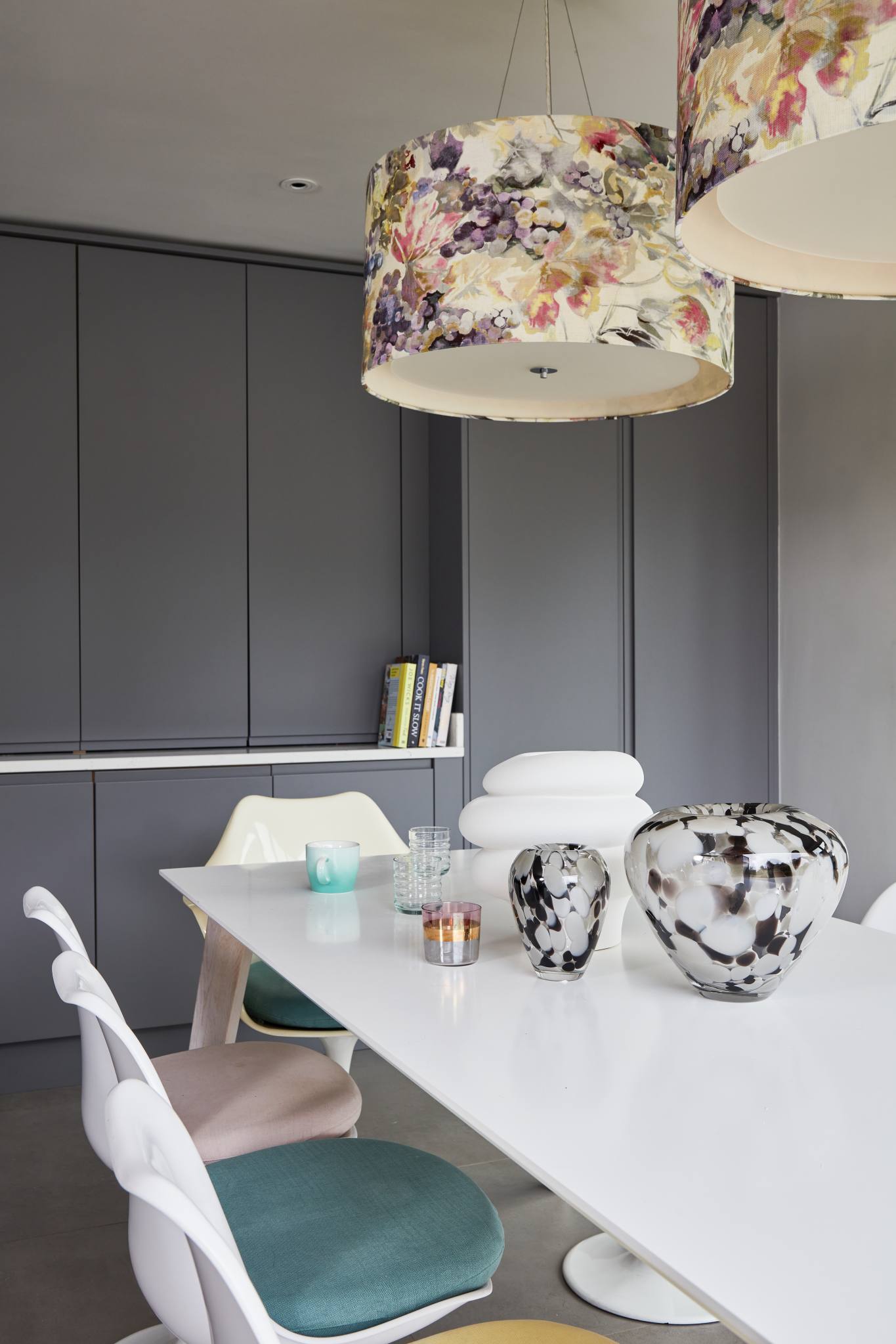 Chic dining space with statement floral pendant lighting in a Surrey countryside kitchen.