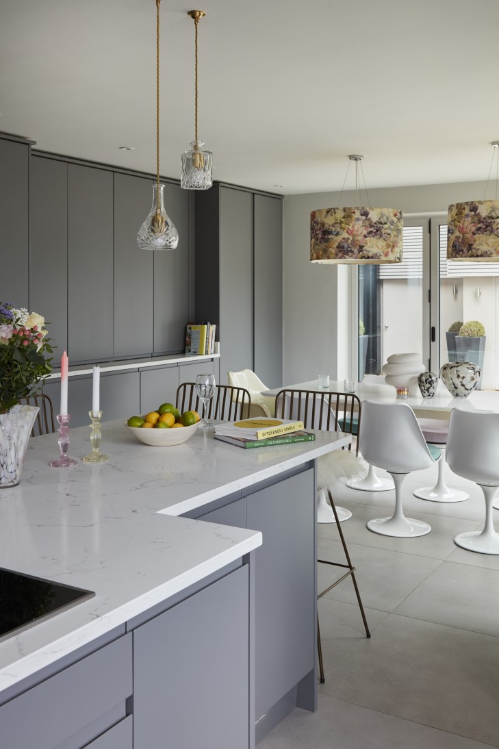 Luxury open-plan kitchen with an island, gold lighting, and modern dining area.