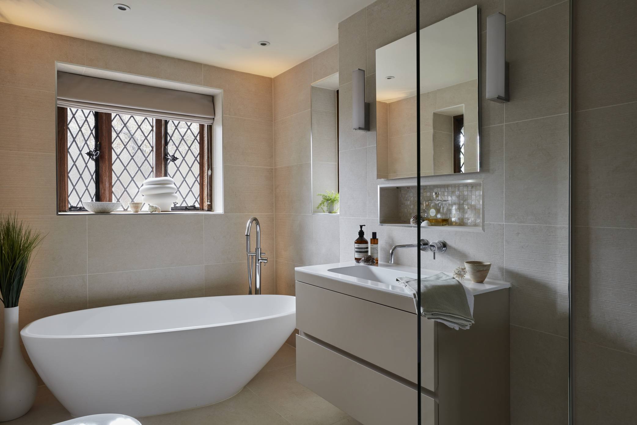 Spa-like ensuite with a freestanding bathtub and marble flooring.