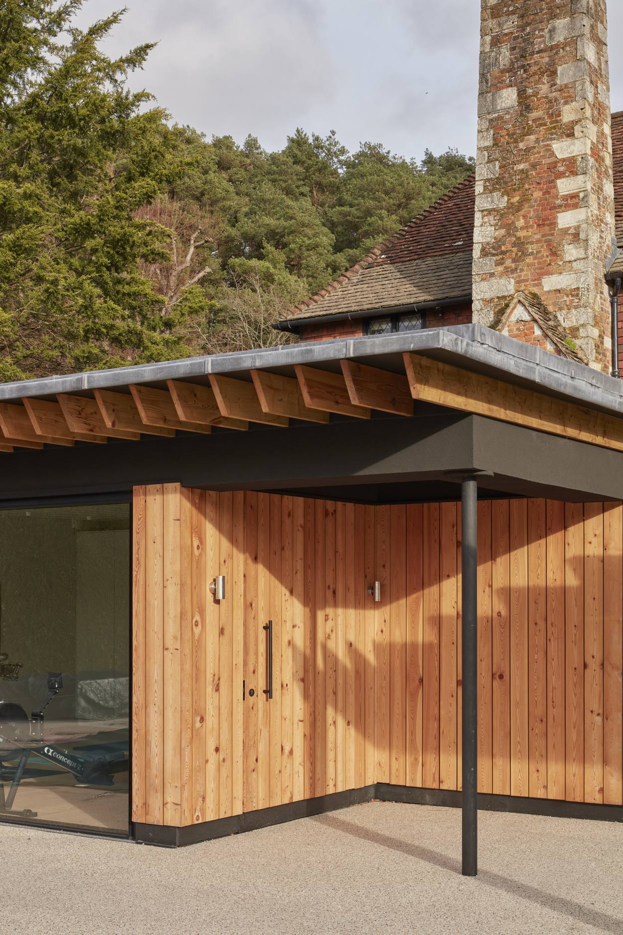 Exterior of a contemporary wooden pool house in a Surrey countryside home